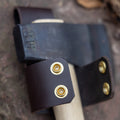 Close up of brass snap closure on axe belt holder