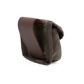 This waxed canvas pouch designed to hold axe sharpening pucks attaches to the hip by a full-grain leather belt loop.