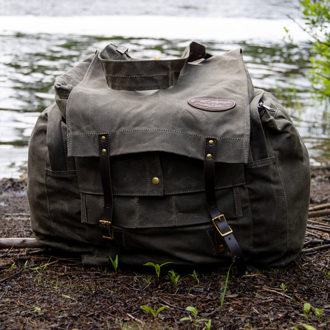 Frost River's waxed canvas canoe pack sitting at the end of a portage. 