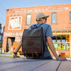 Man wearing a waxed canvas and leather Premium Mesabi Range Pack