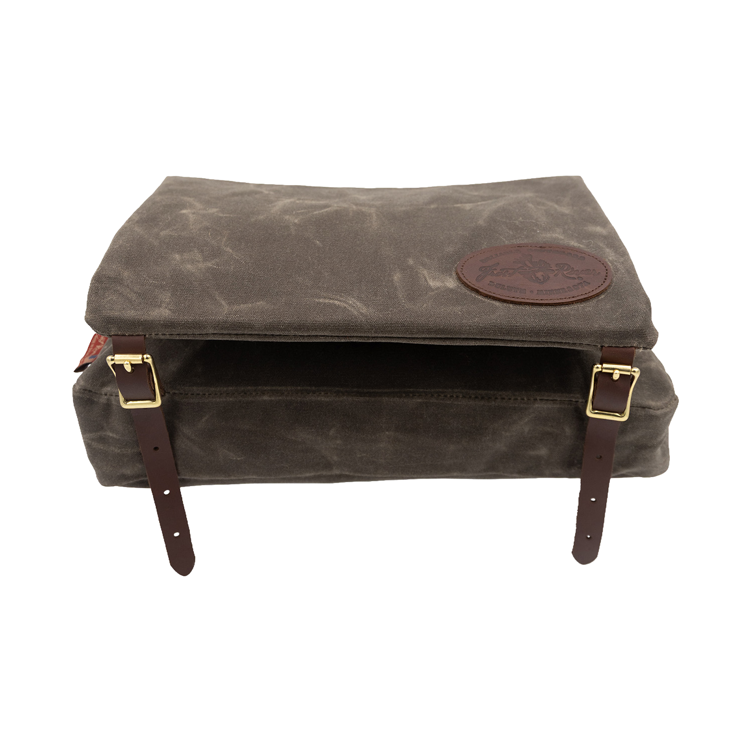 A waxed canvas canoe seat pad that has an attached bag that hangs underneath the canoe seat. 