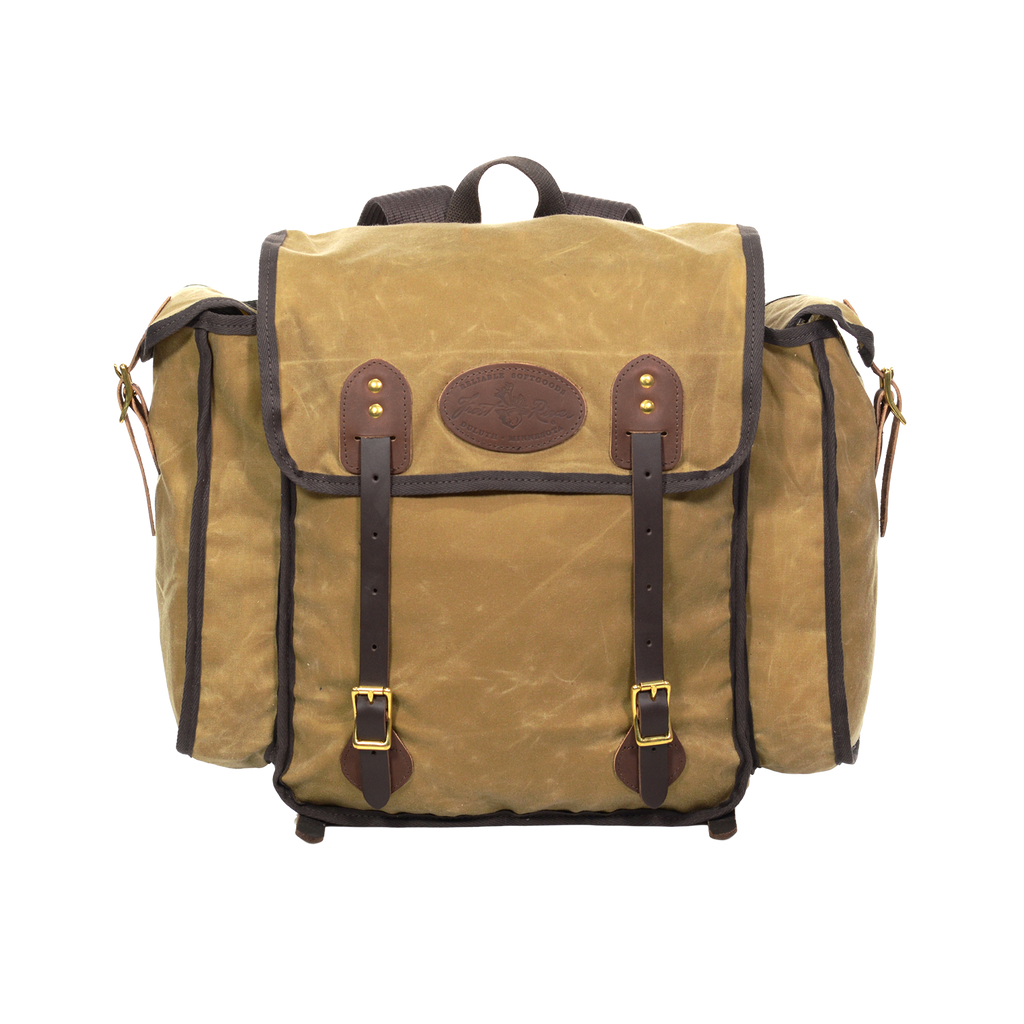 The Cliff Jacobson is a light weight tan colored box style pack. With two leather straps in the front to secure your load. Handcrafted in Duluth, MN.