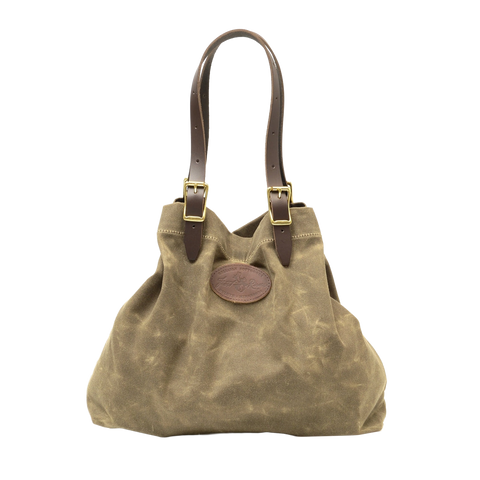 Large tote with adjustable leather straps connected with solid brass buckles.