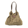 Large tote with adjustable leather straps connected with solid brass buckles.