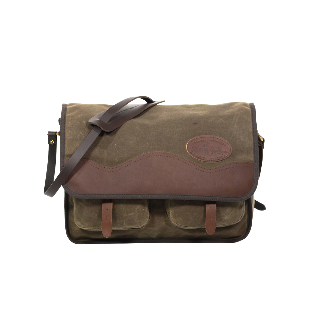 The larger sibling of the Little Manitou Shoulder Bag, still handcrafted out of high-end waxed canvas, premium leather, strong webbed cotton, and solid brass.