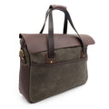 Angled view of a waxed canvas and leather briefcase showing off the solid brass d-rings for holding the shoulder strap. 