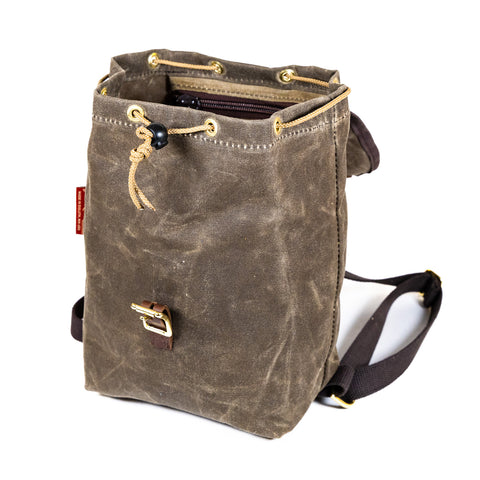 A mini knapsack with the top lid open showing off that it has a drawstring closure. 