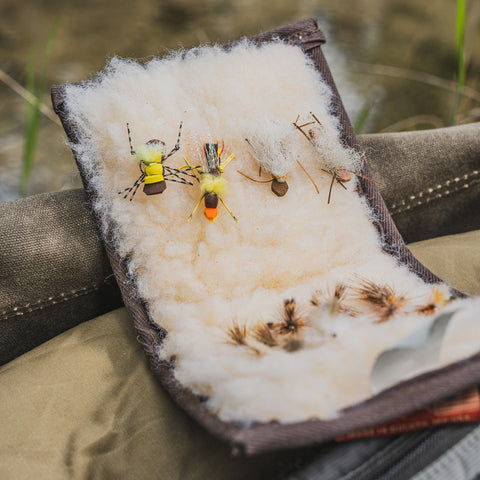 A fly wallet folding a variety of fly fishing lures. 