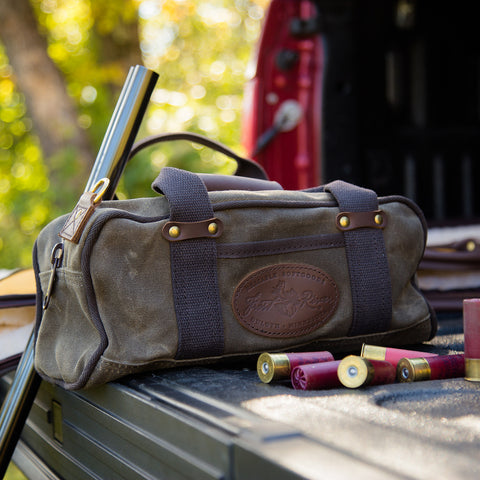 Waxed canvas and leather ammo bag sitting on a truck tailgate. 