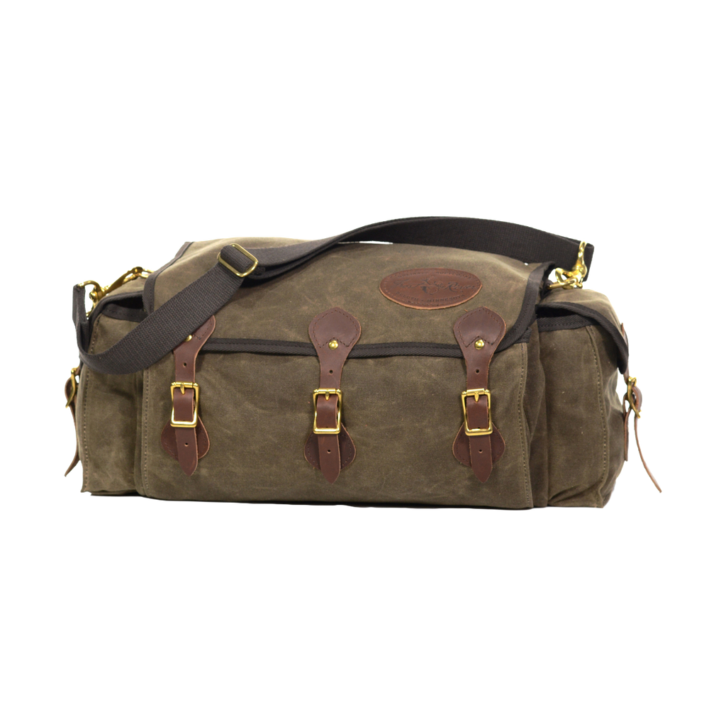 A soft sided tackle box crafted from waxed canvas, leather, and solid brass. 
