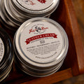 A close up stack of Frost River's Leather Cream. 