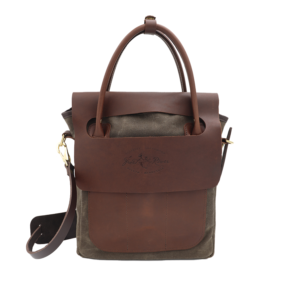 Brown leather and waxed canvas bag with a visible brand logo on a white background.